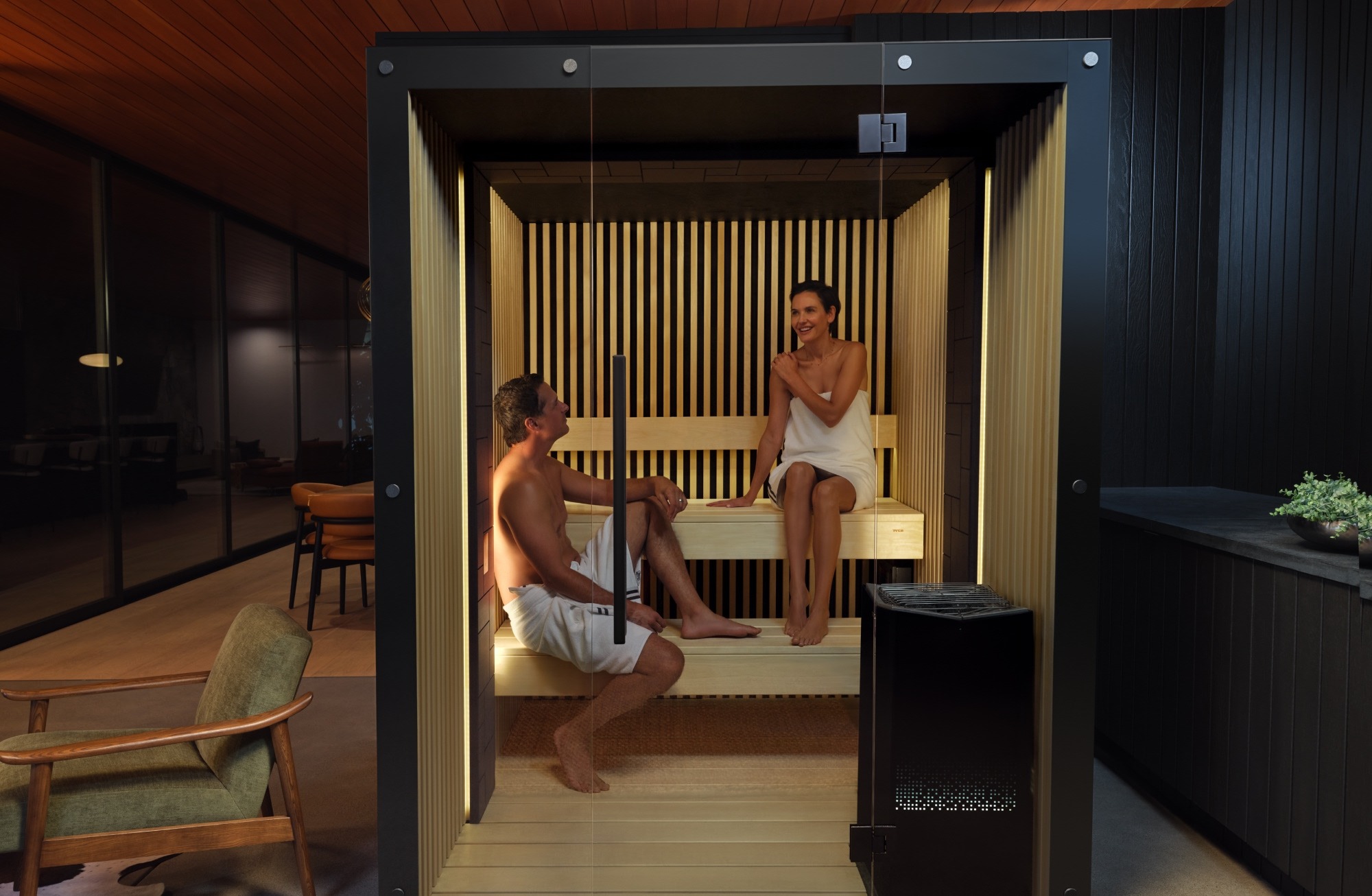 Two people sitting in a Reflection sauna