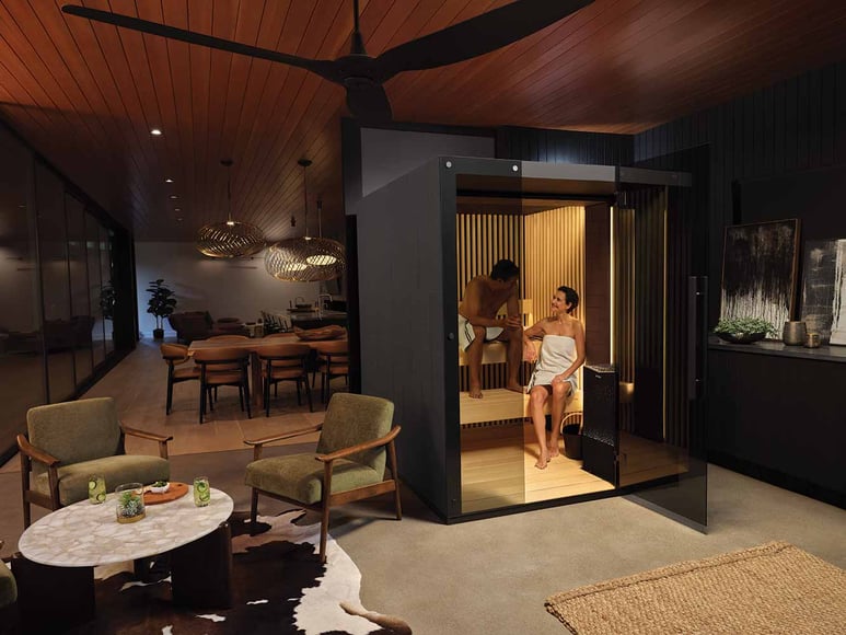 Two people sitting in a Reflection sauna