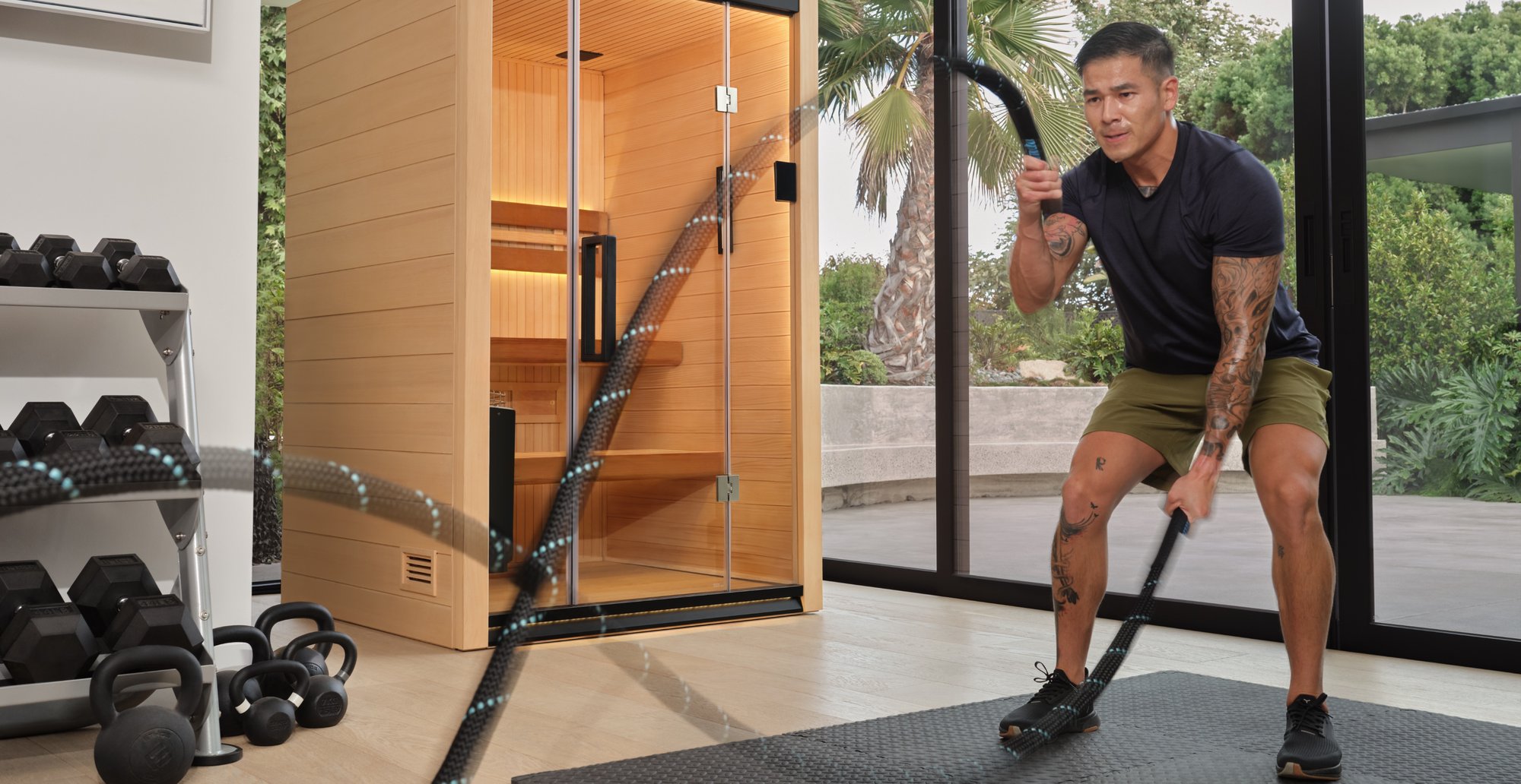 A person using exercise ropes in front of a Halmstad sauna