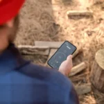 A person looking at their phone with the Tylo lifestyle app open