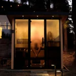 Two people sitting in a Tylo Lulea sauna at night